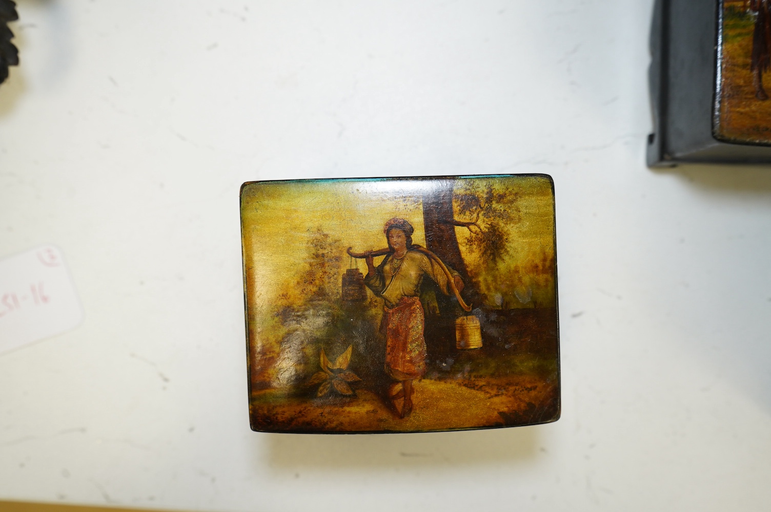 Three late 19th century Russian lacquer boxes, covers painted with Russian provincial scenes, largest14cm wide. Condition - varied